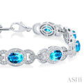 1/10 ctw Oval Cut 7x5MM Blue Topaz and Round Cut Diamond Semi Precious Bracelet in Sterling Silver